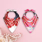 Two patterned bandanas with decorative bows on a pink background with pearls.