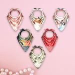 Set of colorful bandana-style scarves on a pink background