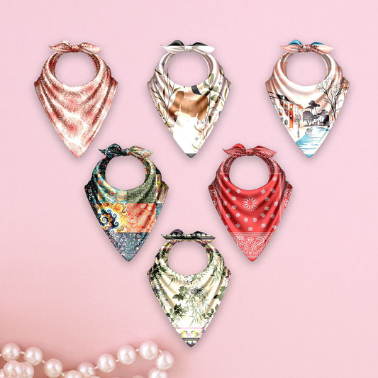 Set of colorful bandana-style scarves on a pink background