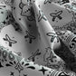 Close-up of patterned fabric with black designs on a white background