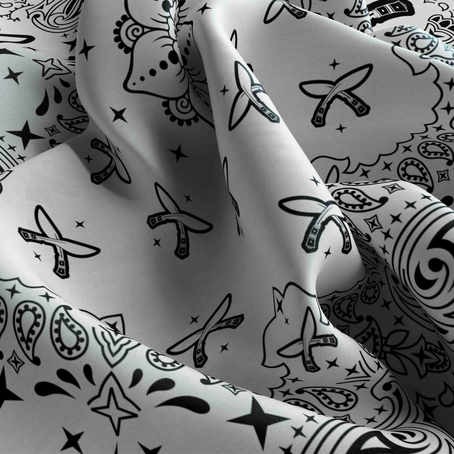 Close-up of patterned fabric with black designs on a white background