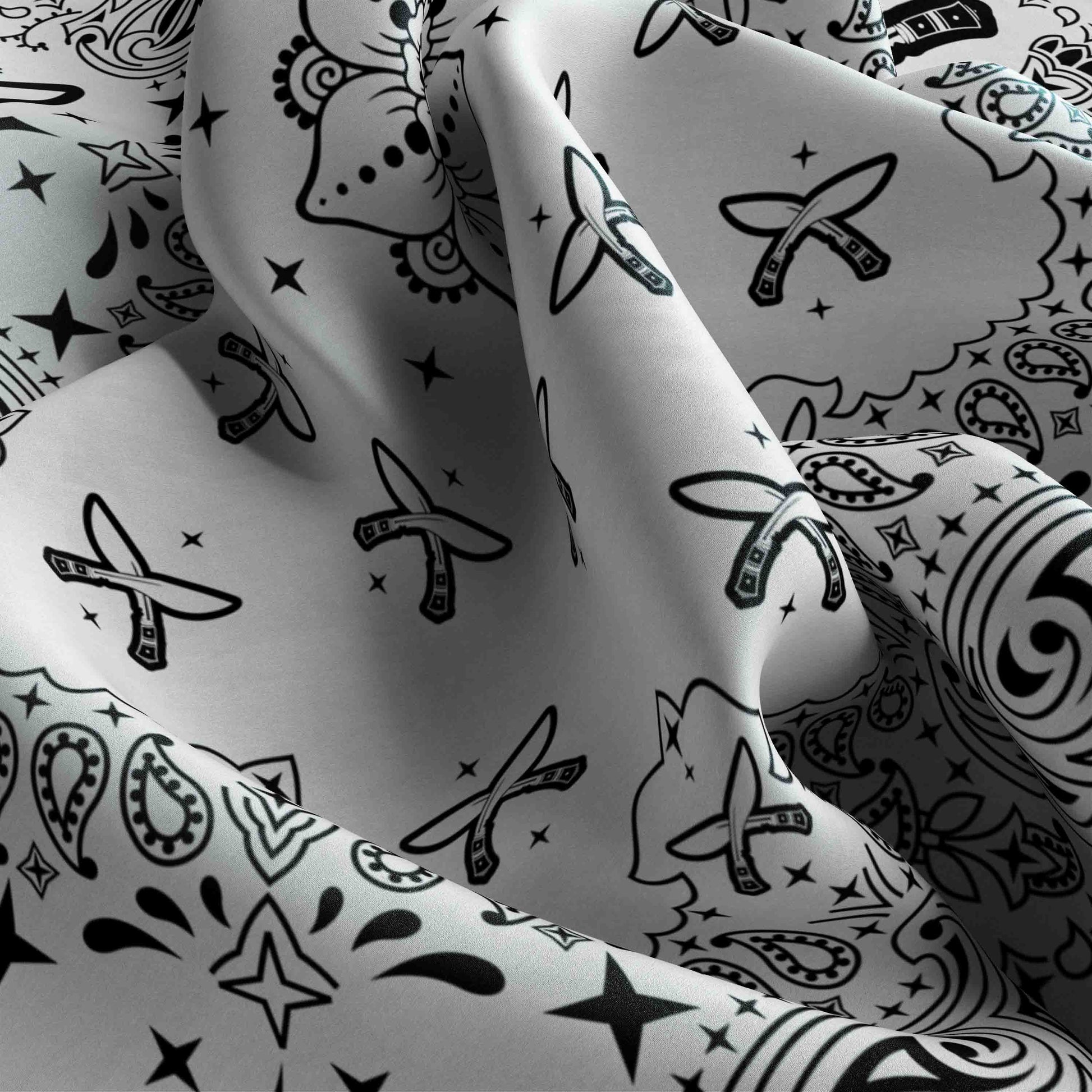 Close-up of patterned fabric with black designs on a white background