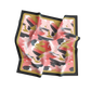 Colorful patterned fabric with black, red, and gold design on a white background