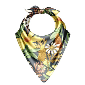 Floral patterned bandana with yellow flowers and green leaves on a white background