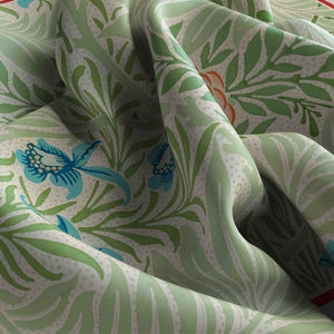 Fabric with green floral pattern and blue butterfly design