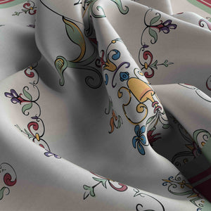 Close-up of patterned fabric with colorful designs on a white background