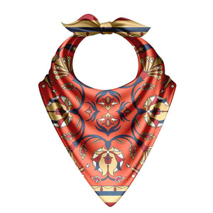 Decorative bandana with a red and gold pattern on a white background