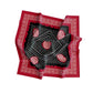 Red bandana with black and white patterns on a white background
