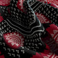 Black and white patterned fabric with red accents on a matching background