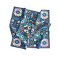 Folded floral patterned fabric on a white background