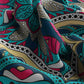 Colorful fabric with abstract pattern in teal, pink, and yellow