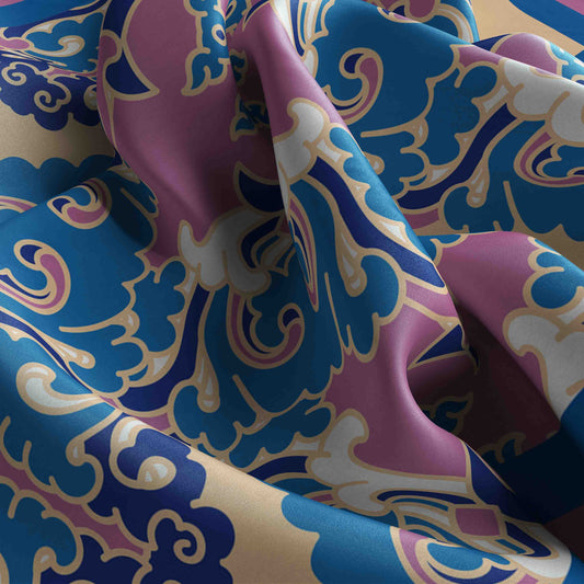 Close-up of colorful fabric with intricate patterns in blue, pink, and white.