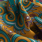 Close-up of a colorful patterned fabric with intricate designs.