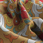 Close-up of colorful fabric with abstract pattern on a beige background