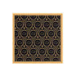 Decorative mat with gold pattern on a black background, framed in wood.