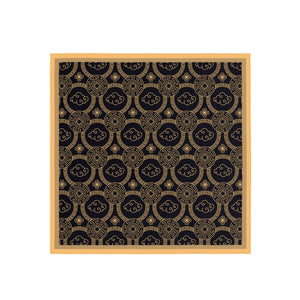 Decorative mat with gold pattern on a black background, framed in wood.
