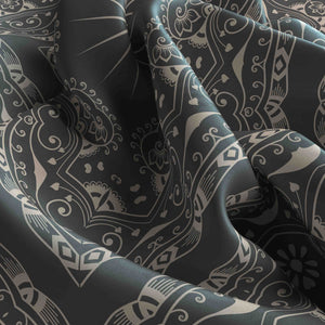 Close-up of dark fabric with intricate white patterns
