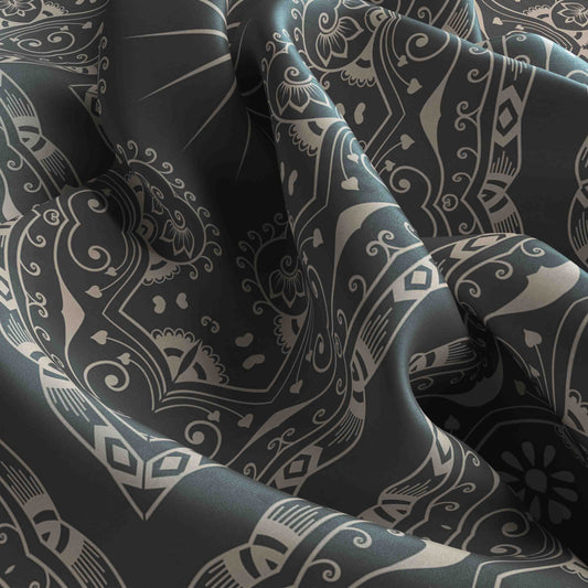 Close-up of dark fabric with intricate white patterns
