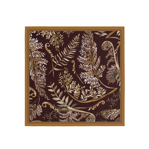 Fern patterned fabric with a wooden frame on a white background