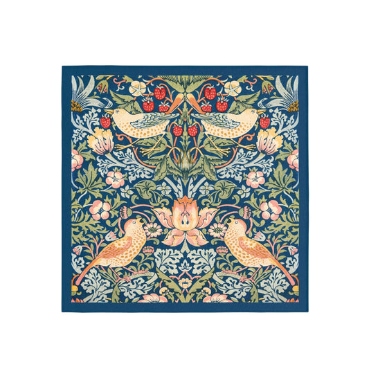 Decorative fabric square with floral and bird pattern on a blue background