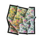 Colorful tropical leaf patterned towel with black border on a white background