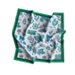 Floral patterned fabric with green border on a white background
