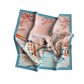 Scarf with a scenic design featuring buildings and trees on a white background