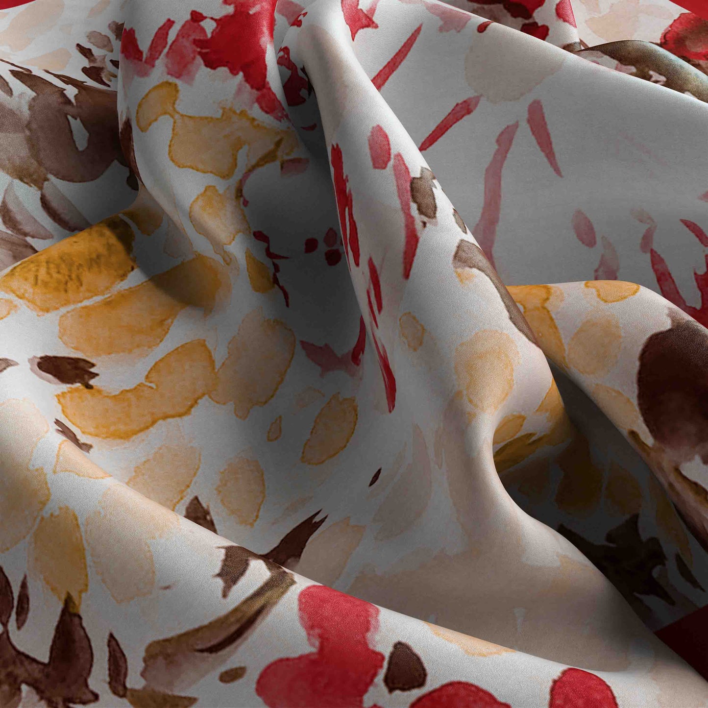 Close-up of fabric with abstract pattern in red, brown, and yellow on a white background
