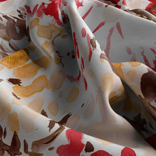 Close-up of fabric with abstract pattern in red, brown, and yellow on a white background
