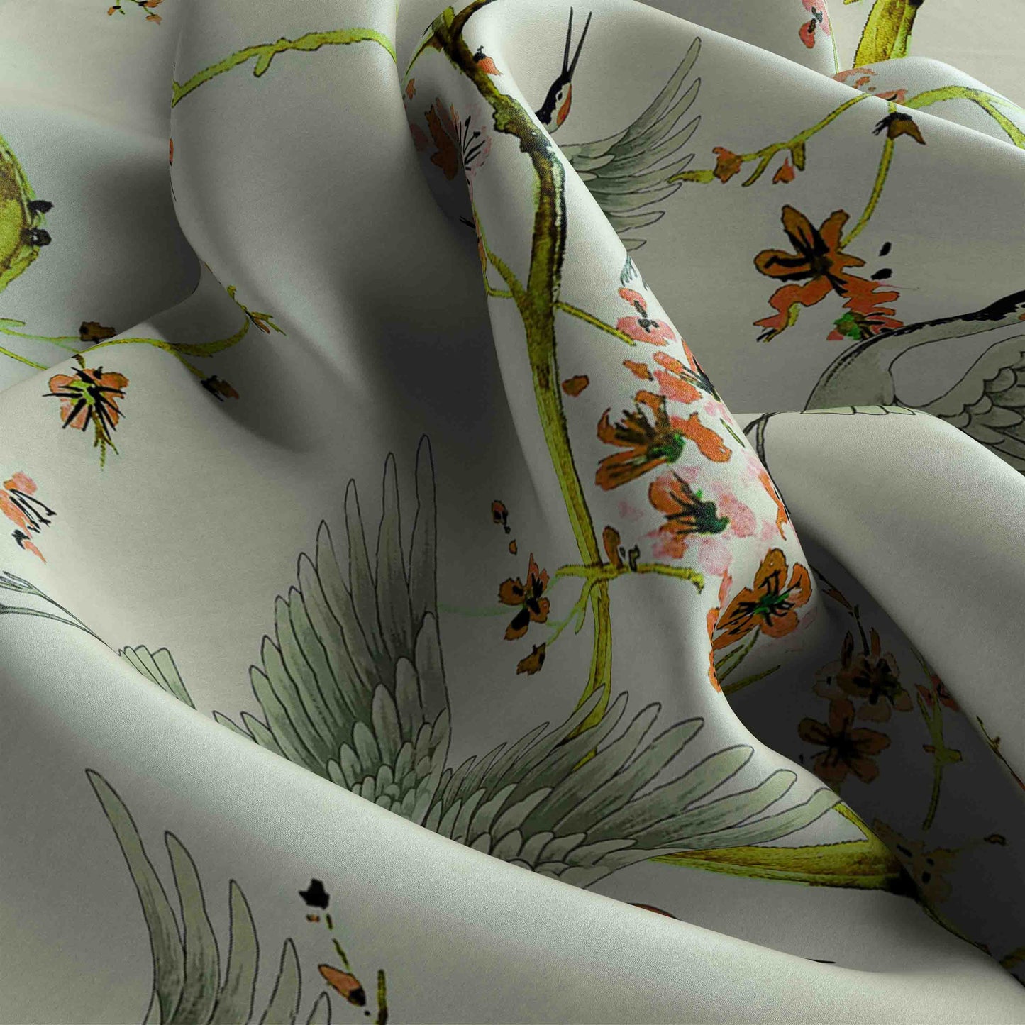 Floral and bird patterned fabric with green, orange, and black colors on a white background.