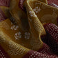 Close-up of patterned fabric with white floral designs on a dark background