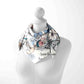 Mannequin wearing a floral scarf with text on a white background