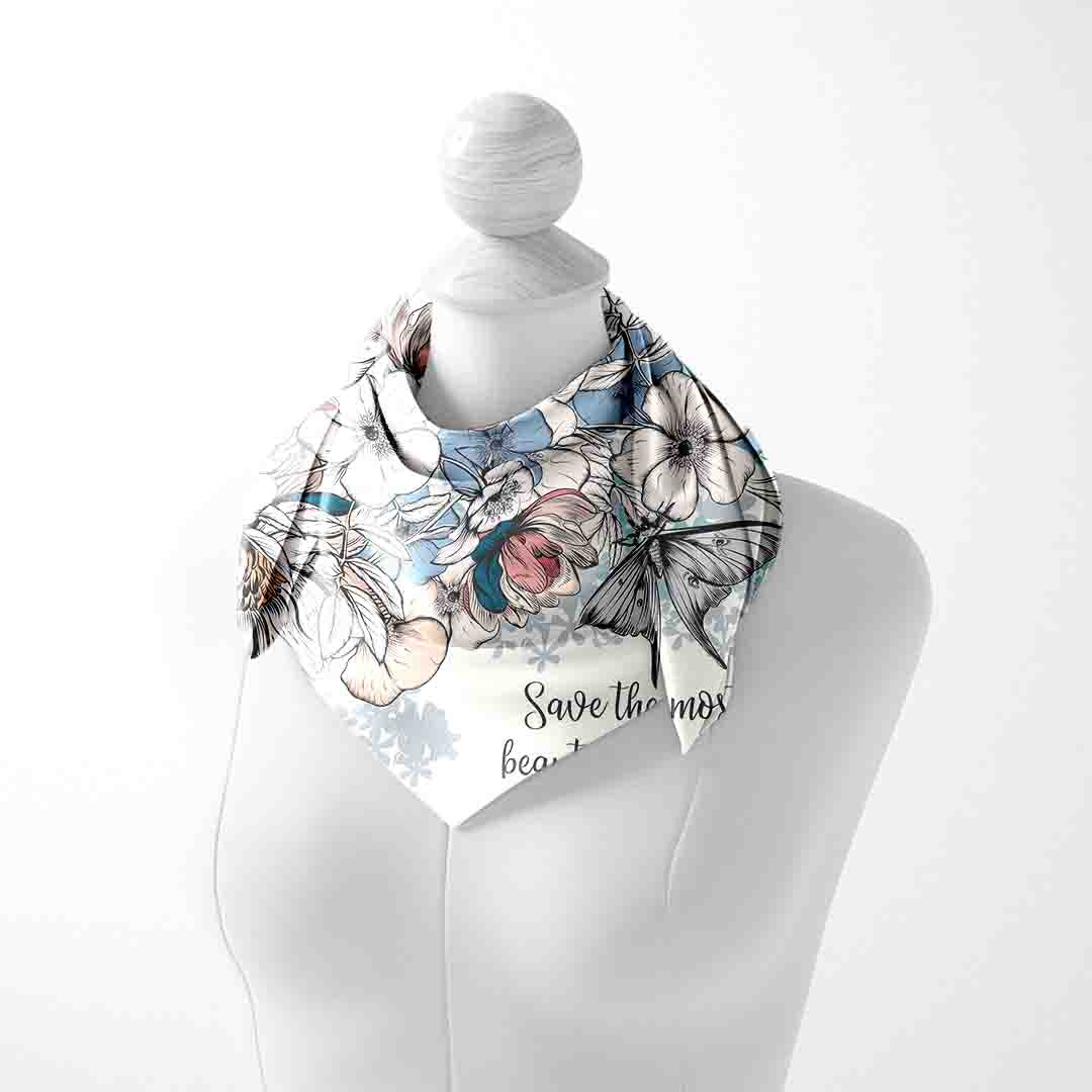 Mannequin wearing a floral scarf with text on a white background