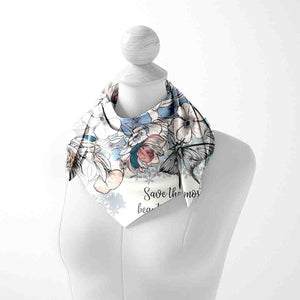 Mannequin wearing a floral scarf with text on a white background