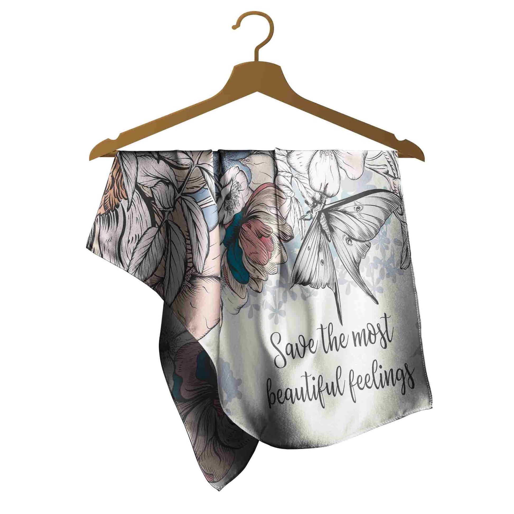 Scarf with butterfly design and text on a hanger against a white background