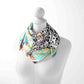 Necklace with a colorful patterned scarf on a mannequin against a white background