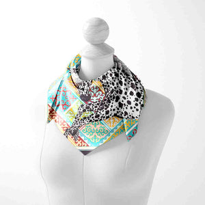 Necklace with a colorful patterned scarf on a mannequin against a white background