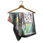 Colorful patterned scarf on a wooden hanger against a white background