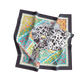 Colorful patterned scarf with a Dalmatian dog design on a white background