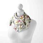 Floral patterned scarf on a mannequin against a white background