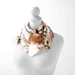 Floral scarf on a mannequin with a white background