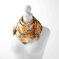 Mannequin wearing a colorful patterned scarf on a white background