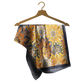 Patterned fabric on a wooden hanger against a white background