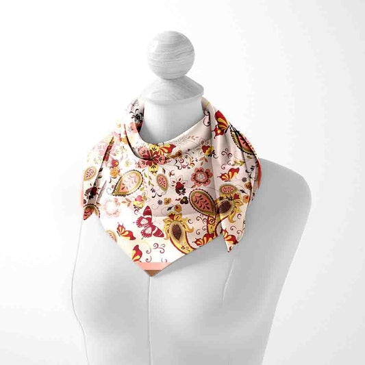 Decorative scarf with floral and paisley pattern on a mannequin against a white background