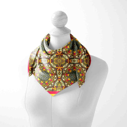 Colorful patterned scarf on a mannequin against a white background