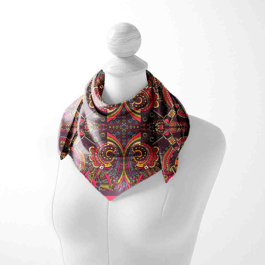 Colorful paisley patterned scarf on a mannequin against a white background