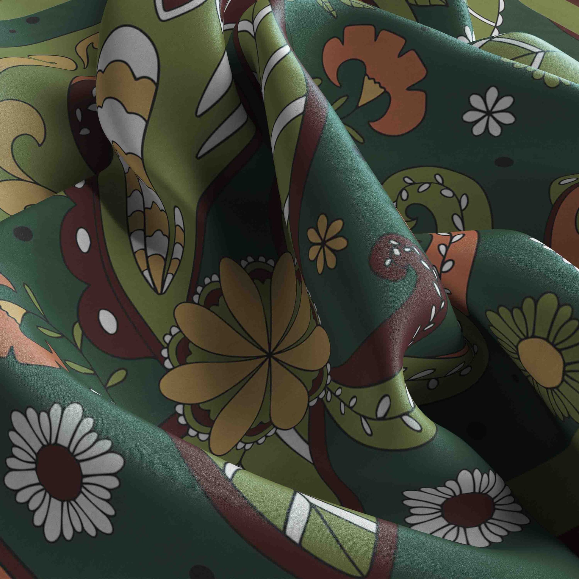 Close-up of a colorful fabric with floral and abstract patterns on a green background.