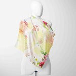 Colorful floral scarf on a mannequin against a white background