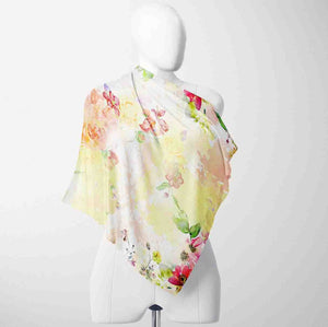 Colorful floral scarf on a mannequin against a white background