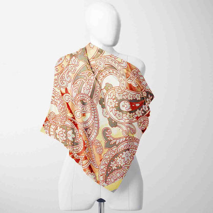 Colorful paisley patterned scarf on a mannequin against a white background